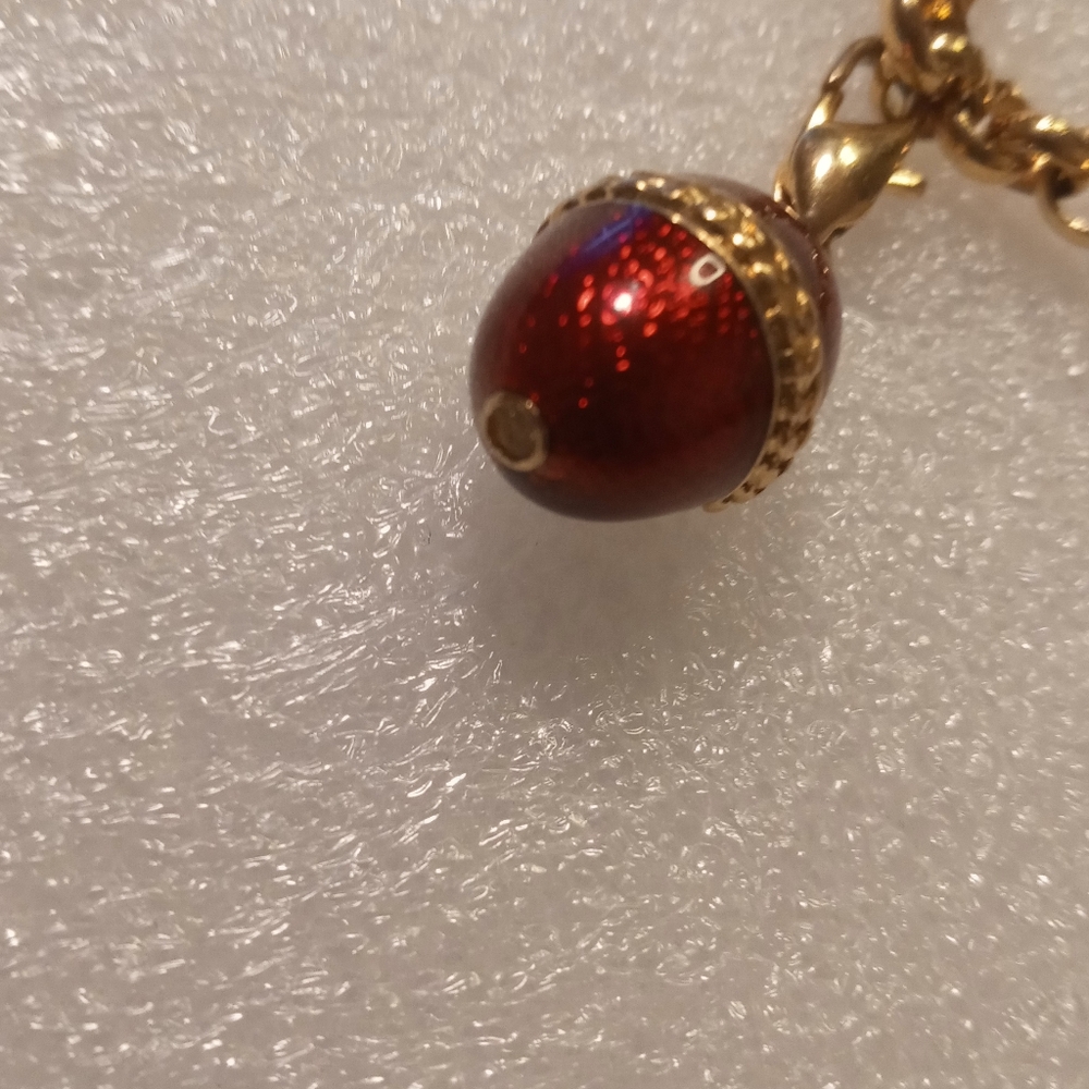 Faberge egg charm bracelet on a gold tone rolo chain. - Picture 15 of 16